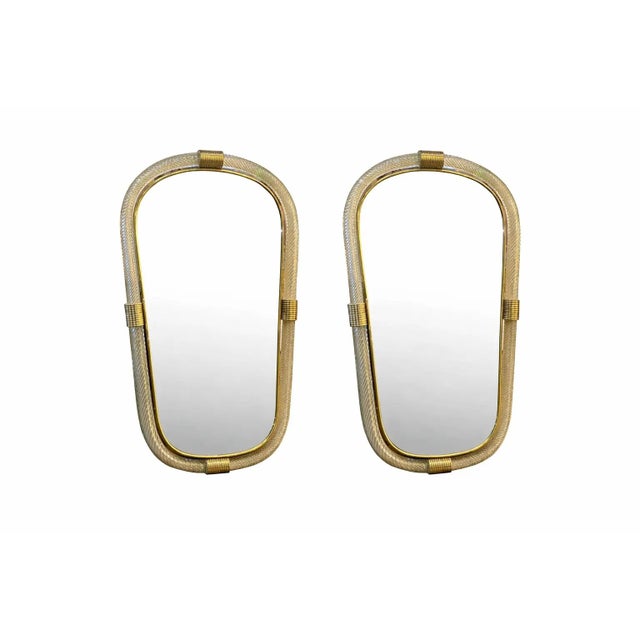 Pair of Italian Murano Glass Wall Mirrors in Gold Leaf “Torciglione” Venetian Design Scenographic wall mirror in brass...
