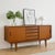 Stunning Mid Century Modern teak credenza handcrafted in Scandinavian style. This timeless piece features a sleek,...