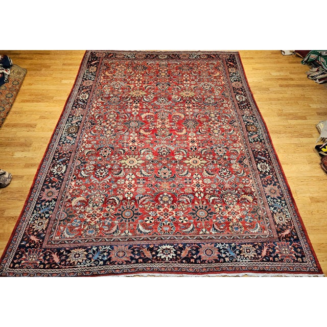 "A captivating example of early 20th-century Persian craftsmanship, this vintage oversized Mahal Sultanabad rug features a...