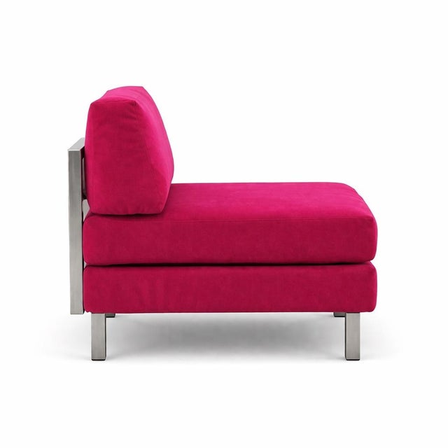 A bold and sculptural modern slipper lounge chair with matching ottoman, upholstered in vibrant magenta velvet. Featuring...