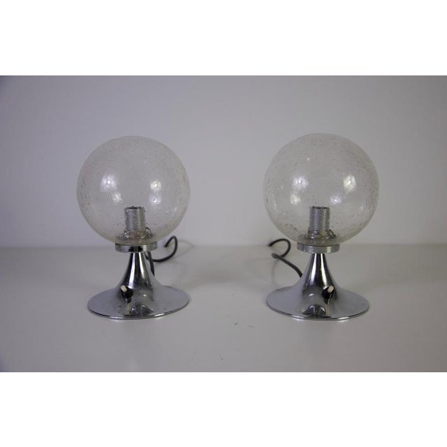 Pair of chrome and glass table lamps, germany, 1960s. This striking set of vintage lamps features spherical textured glass...