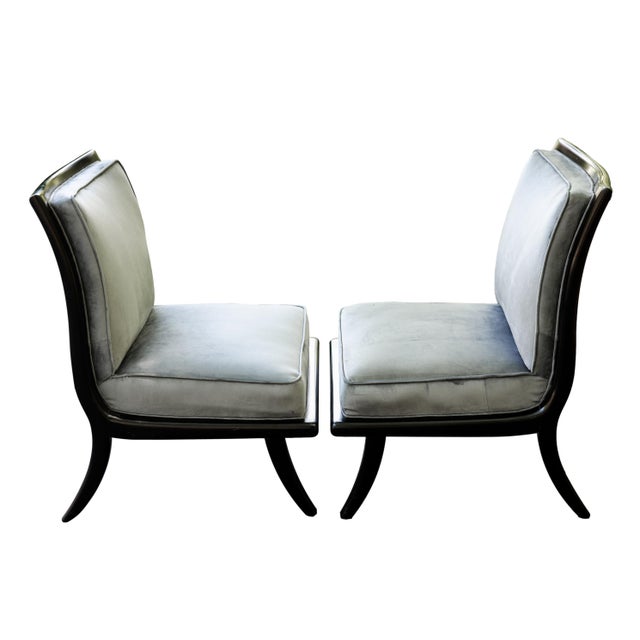 Pair of Mid-Century Modern/Art Deco lounge chairs, the thick, shaped frame constructed of ebonized hardwood, with flared...