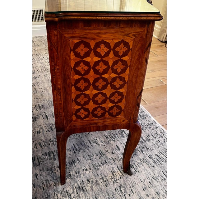 This charming inlaid French table has romantic scenes on the front and the top. The uniquely French cabriole legs add a...