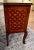 This charming inlaid French table has romantic scenes on the front and the top. The uniquely French cabriole legs add a...
