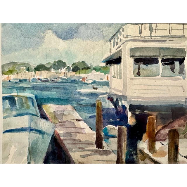Original watercolor on paper depicting a waterfront lighthouse or harbor building marked “L.J. Quinn’s Lighthouse,” with...