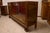 Art deco sideboard in walnut briar with two sliding glasses, curly carved feet, a closed door and two drawers, complete...