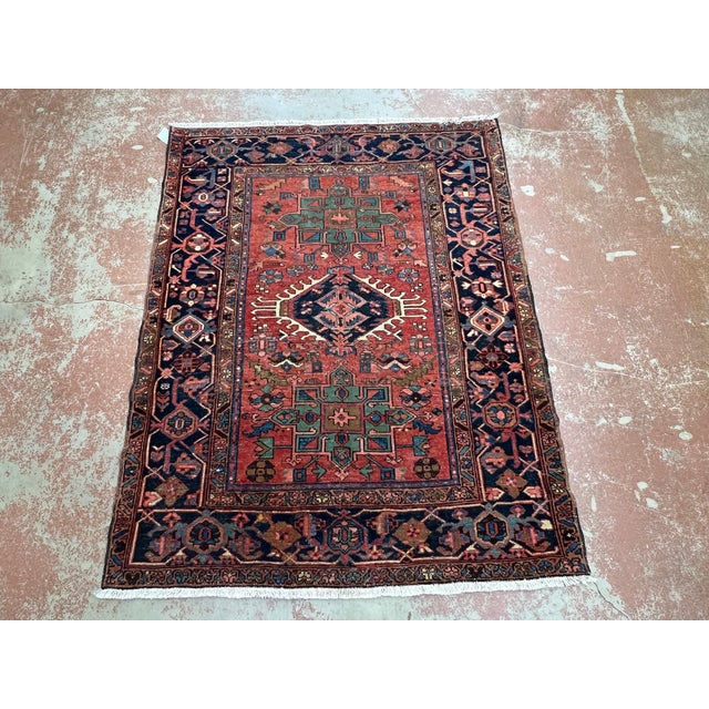 Antique Persian Karajeh rug, hand-knotted in Iran from 100% wool. Measuring 4’8” x 5’11”, the rug features a traditional...