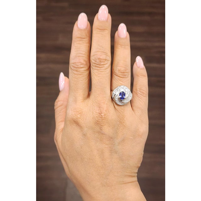 This stunning vintage-inspired cocktail ring showcases a 1.56-carat oval-shaped tanzanite in a vivid, rich blue hue. The...