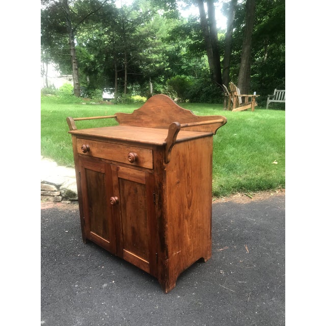 This antique early American cabinet brings warmth, traditional character and the tactile appeal of the carpenter's craft.