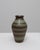 This 20th Century German ceramic vase features a refined blend of earthy tones and subtle geometric detailing,...