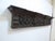 This carved oak shelf measures 9.5"H x 48.5"L x 6"D. It hangs from two bales on the back.