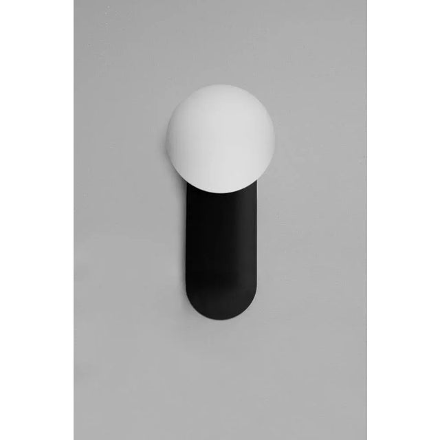 Adrion wall sconce md by schwung dimensions: w 15 x d 16.1 x h 30.5 cm materials: black gunmetal, frosted glass. All our...