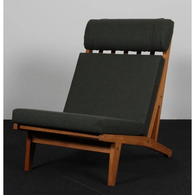 Hans j. Wegner lounge chair with loose cushions new upholstered with light green magrethe wool from nevotex. Frame of oak....