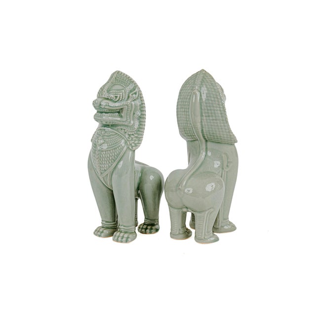 Vintage Thai Singha Lion Foo Dog Statues in Celadon. Produced in the 1960s.The specific tall, slender stance with...