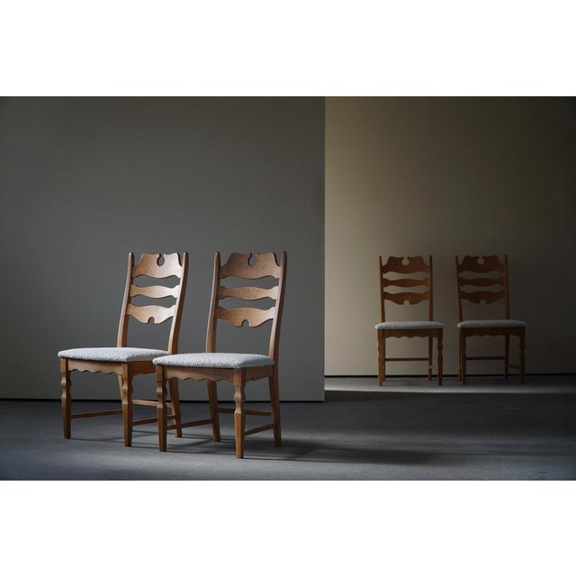 A sculptural classic set of 4 highback razorblade dining chairs in light patinated oak, seats reupholstered in luxurious...