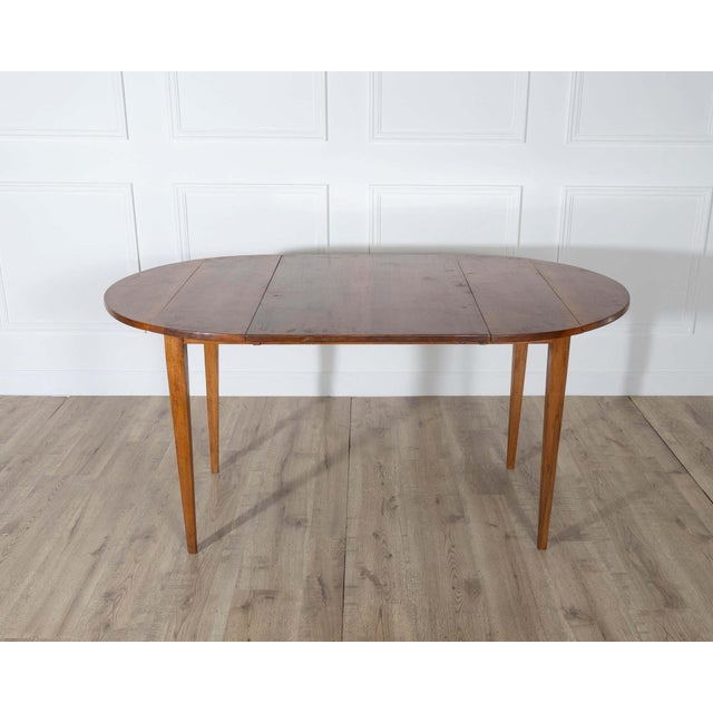 A charming and practical small 19th-century French extension table, crafted entirely in solid walnut, including its...