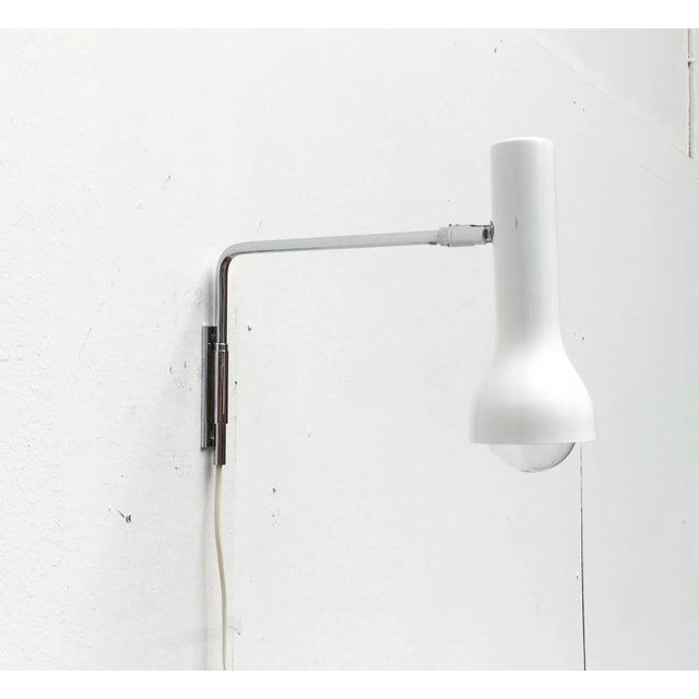Minimalist wall lamps from swisslamps. a very simple and restrained design. The lamp head has a slim spotlight shape. It...