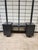 A striking mid-century modern modular vanity desk featuring a dramatic matte black ebonized finish. The architectural...