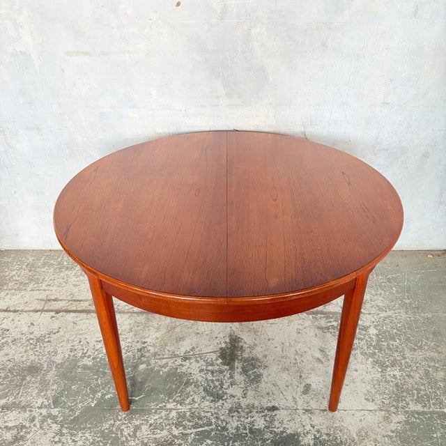 beautifully proportioned mid century Danish extending dining table, crafted in richly grained teak and showcasing the...