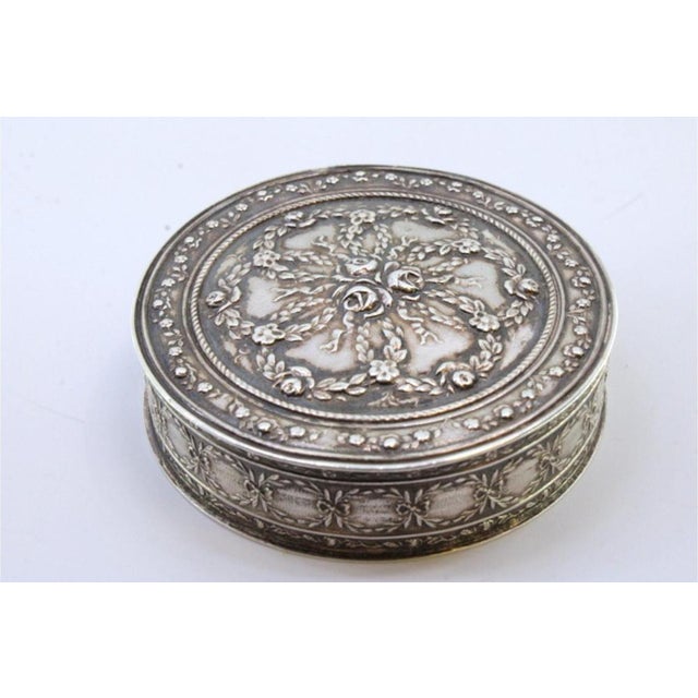 Circular Silver Box with Floral Reliefs and Hinged Lid, in Very Good conditions. Designed before 1890 This piece has an...