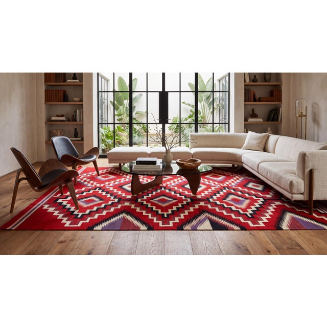 Elevate luxury interiors with this striking contemporary Navajo-style flatweave wool rug, featuring a classic Eye-of-the-...