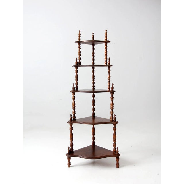 This is an antique corner shelf. The wooden five shelf etagere features stick and ball detailing. Shelf Heights: 5.626",...