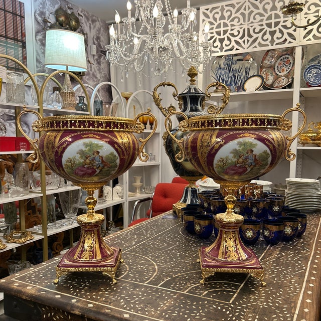 Pair of S Limoges porcelain urns. They feature hand painted scenes and are marked on the undersides. They have a lot of...