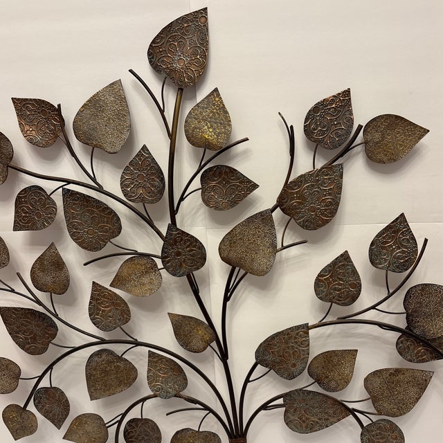 This tree of life has the most interesting colors of bronze, black and turquiose. It stands at 33" high, width at 36.5"...