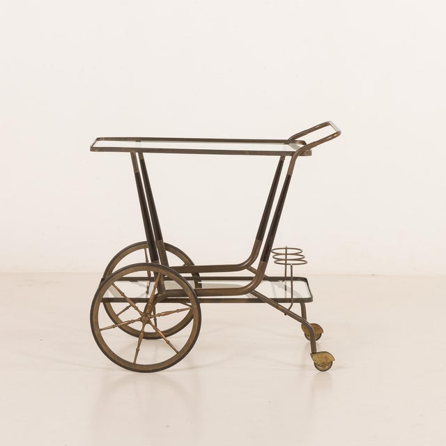 An elegant italian mid-century bar cart that comes from the late 1950s or 1960s and was most likely designed by cesare...