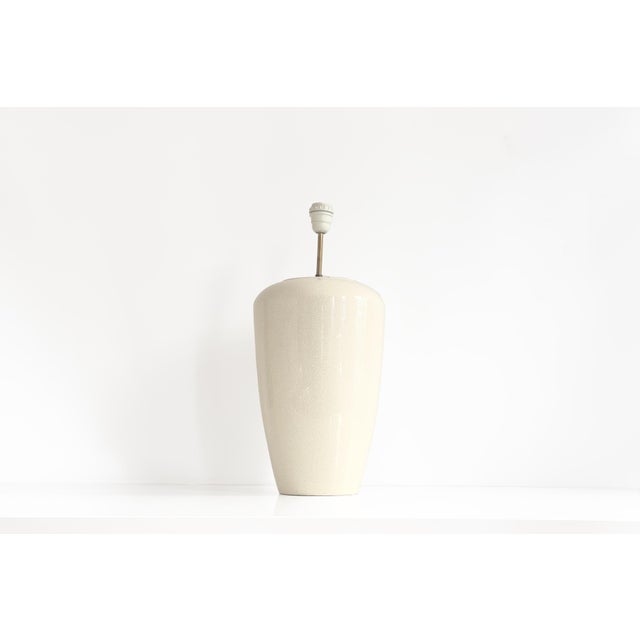 This exquisite 20th-century table lamp signed Charolles, showcases a refined eggshell-effect ceramic finish, exuding both...