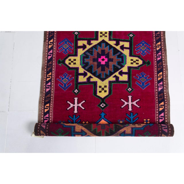 This is a vintage Turkish Oushak rug from the Mid 20th Century. The piece was hand-knotted.