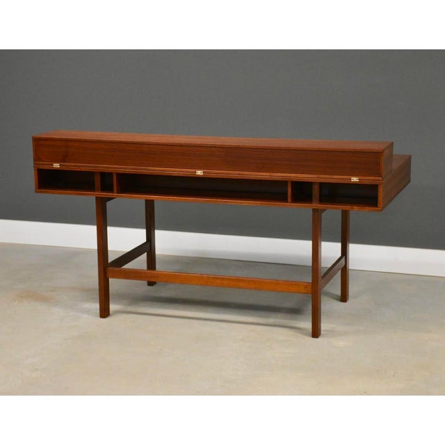 A mid century modern teak flip top desk designed by Peter Løvig signed and dated. Professionally refinished. Dated 1975....