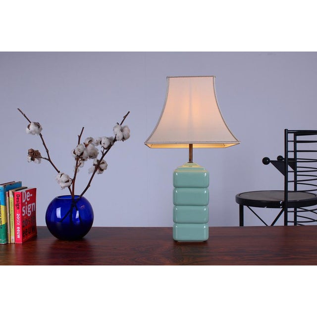 Elegant cubistic shaped ceramic table lamp, Italian style from the 1980ies. Its soft light green, almost turquoise glaze...