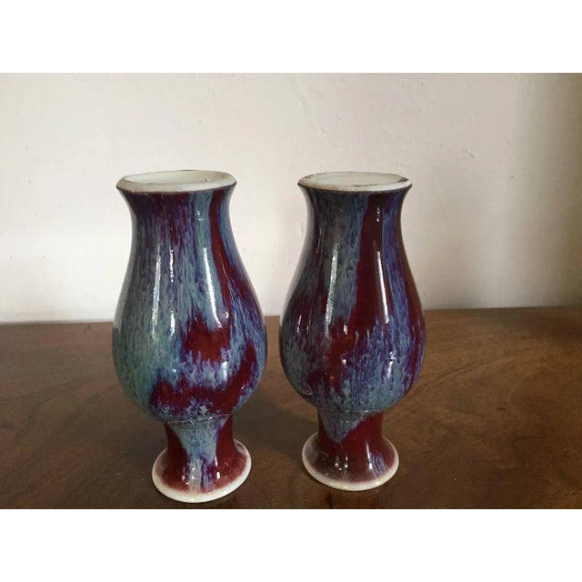 Pair small late Qing Chinese porcelain baluster shaped vases with flambe oxblood glaze. Each measures 5 5/8" tall. Good...