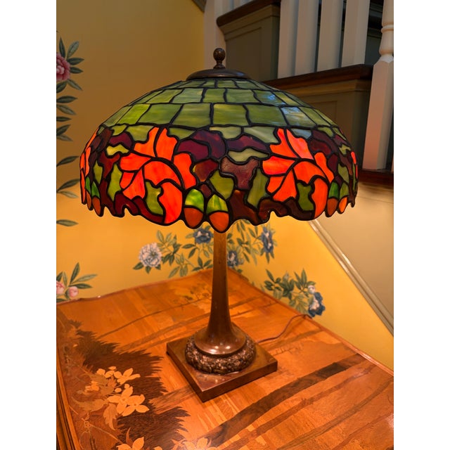 An extremely rare and gorgeous leaded glass and bronze table lamp by Duffner and Kimberly. The shade starts at the top...