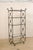 A French Giacometti inspired open display metal étagère with glass shelves. This vintage open case shelving from France...