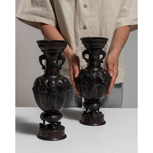 This early 20th century vase from Japan is finished in brass, worked in bronze. Its form follows honest, well-proportioned...