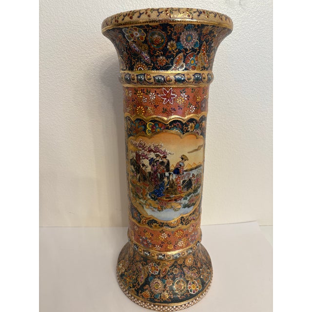 It is a Japanese hand painted vase that is earthenware pottery enameled with gold leaf and the enamel is hand painted. It...