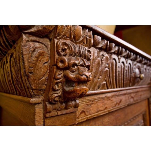 Representative oak chest of drawers from the 18th century, made of solid wood with distinctive plastic carving....