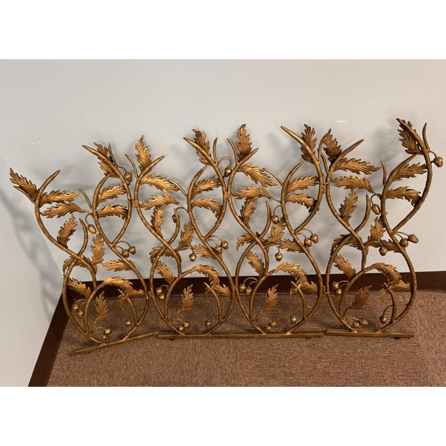 Striking pair of gilt metal decorative screens featuring sculptural acanthus leaves and acorn motifs. Hollywood...