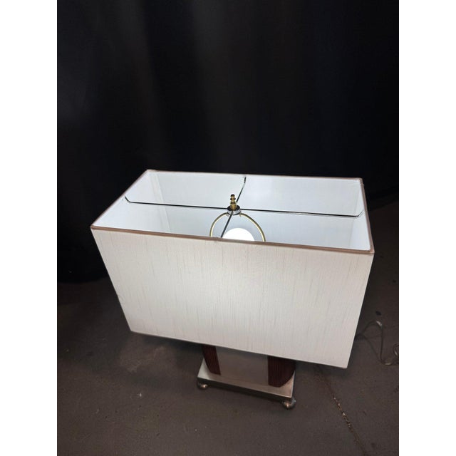 Striking Mid Century Modern table lamp featuring a sculptural Danish-inspired teak wood base accented with polished chrome...