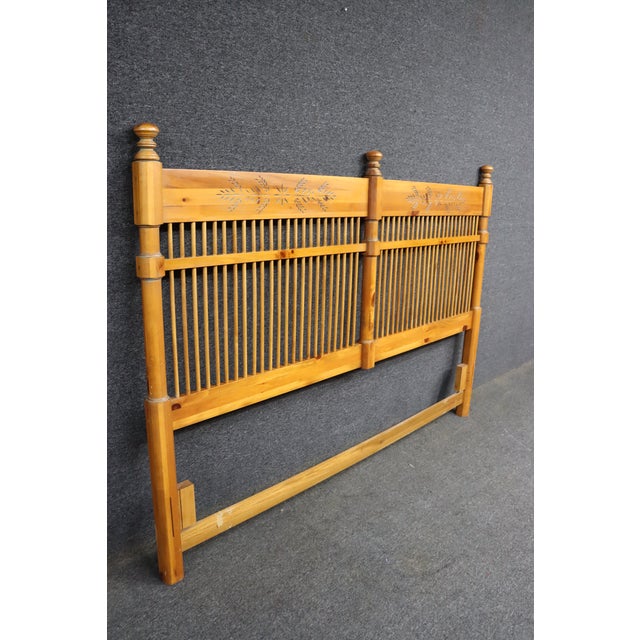 King size pine headboard in a country style design. Features spindle detailing across the center panel with carved...