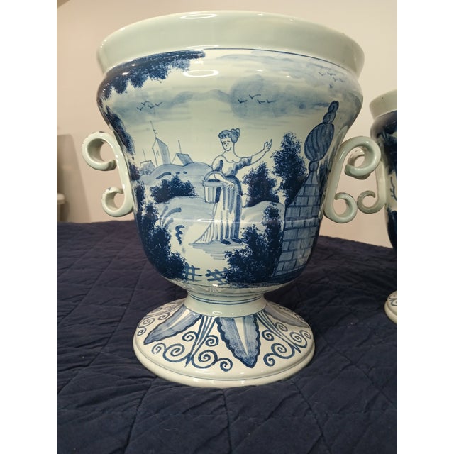 Vintage Delft Williamsburg Restoration pair of decorative urn/vases. They are a beautiful blue and white decorated. They...