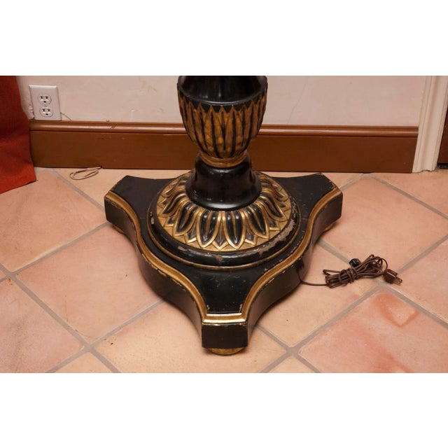 Early 20th century hand carved and turned, electrified torchieres. Condition is original and consistent with age. Gold...