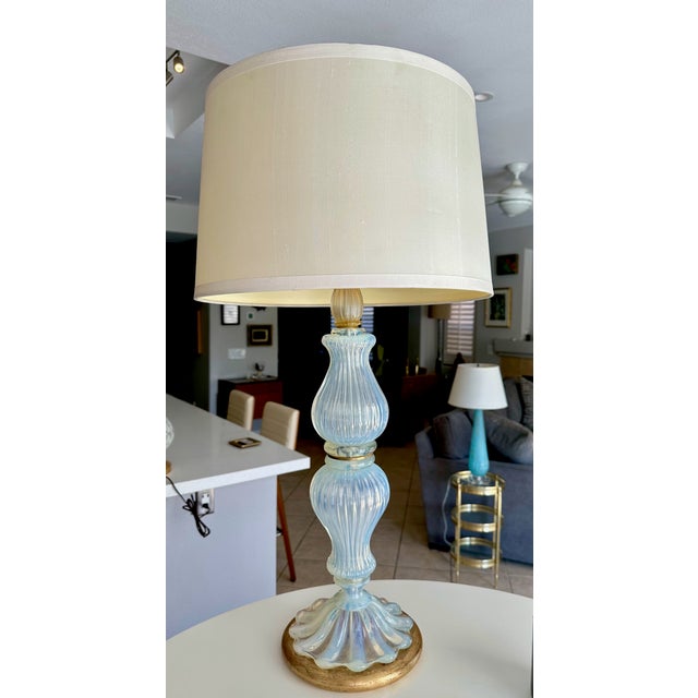 A mid century large scale single Murano blue opalescent colored glass table lamp with gold inclusion elements. Mounted on...