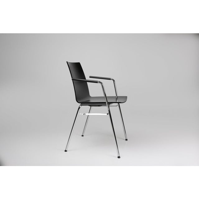 An attractive and comfortable black chair with a wooden seat and metal frame. This multifunctional chair meets high...