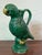 A late-19th or early-20th century porcelain parrot ewer finished in a bold emerald green glaze with bright yellow accents....