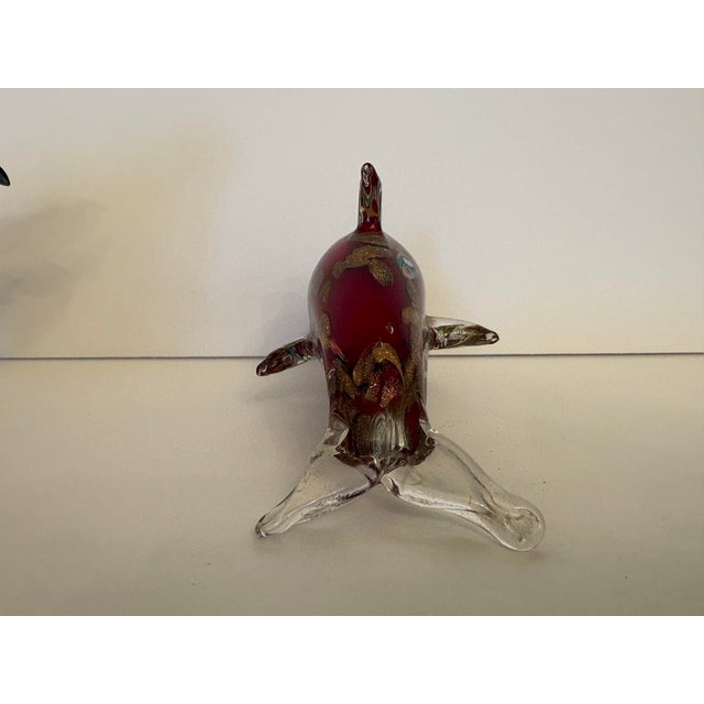This collectible Murano-style red dolphin sculpture featuring milefiori and golden accents. This is a hand blown art glass...