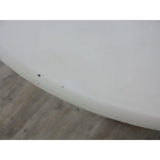 This coffee table was designed and manufactured during the early 1960s in France. It features a white lacquered wooden top...