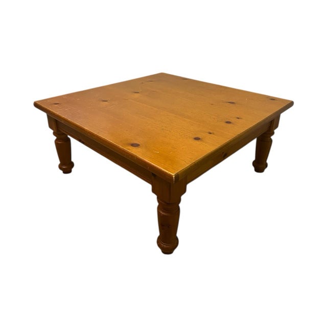 A beautifully crafted solid pine farmhouse coffee table, made in the USA and dated 1991. This table features a warm honey...
